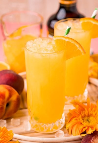 Close up photo of a fuzzy navel in a tall glass.