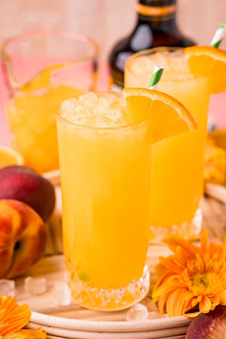 Close up photo of a fuzzy navel in a tall glass.