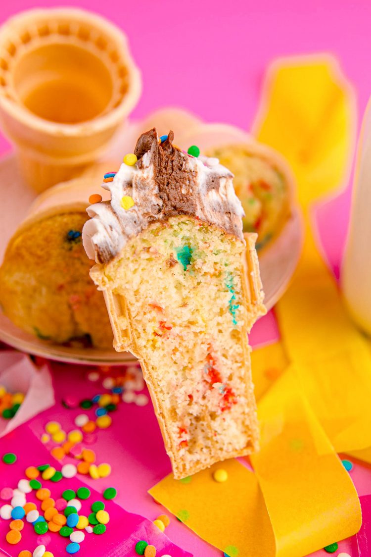 A cupcakes baked into an ice cream cone shown cut in half to reveal the inside.