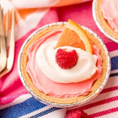 Close up photo of kool-aid pie on a pink and blue striped napkin.