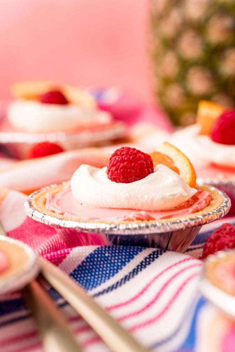 Close up photo of a mini kool-aid pie on a pink, white, and blue striped napkin. 