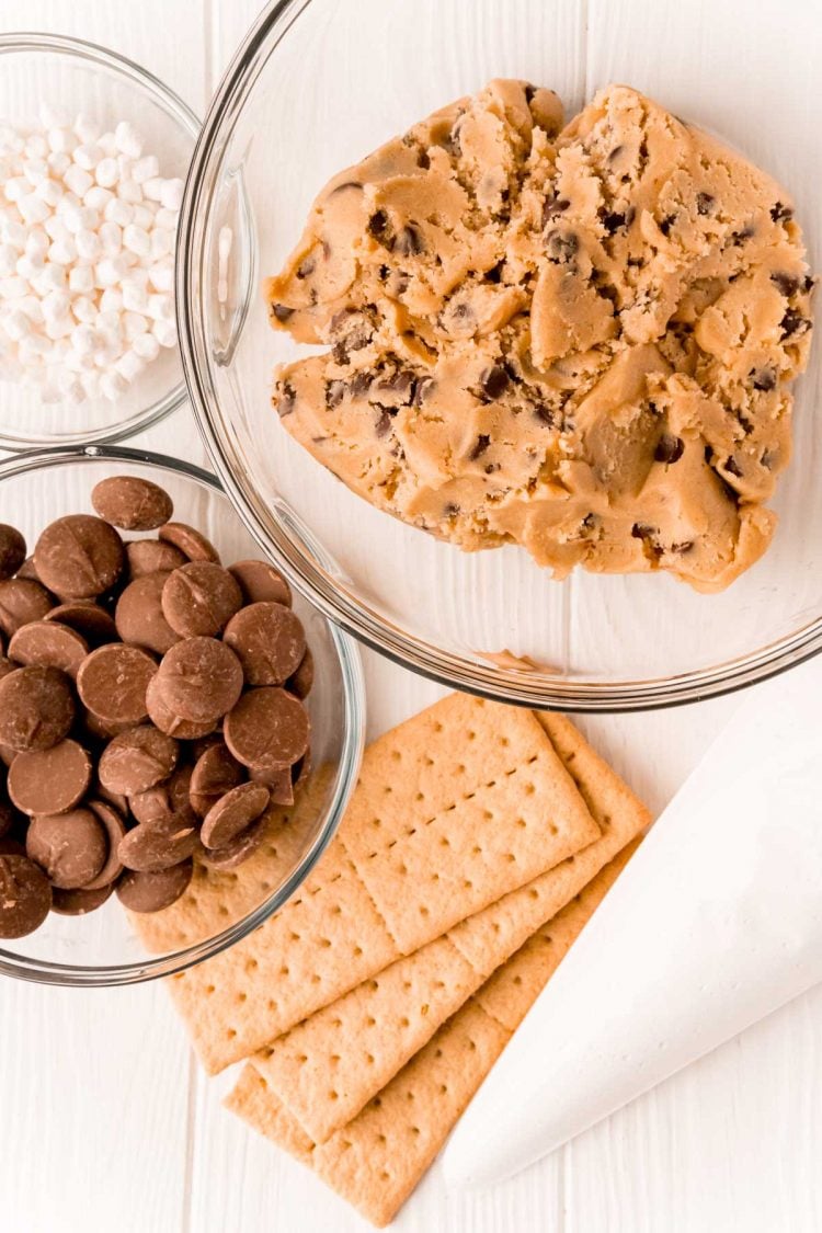 Overhead photo of ingredients to make smores cookies on a white table.