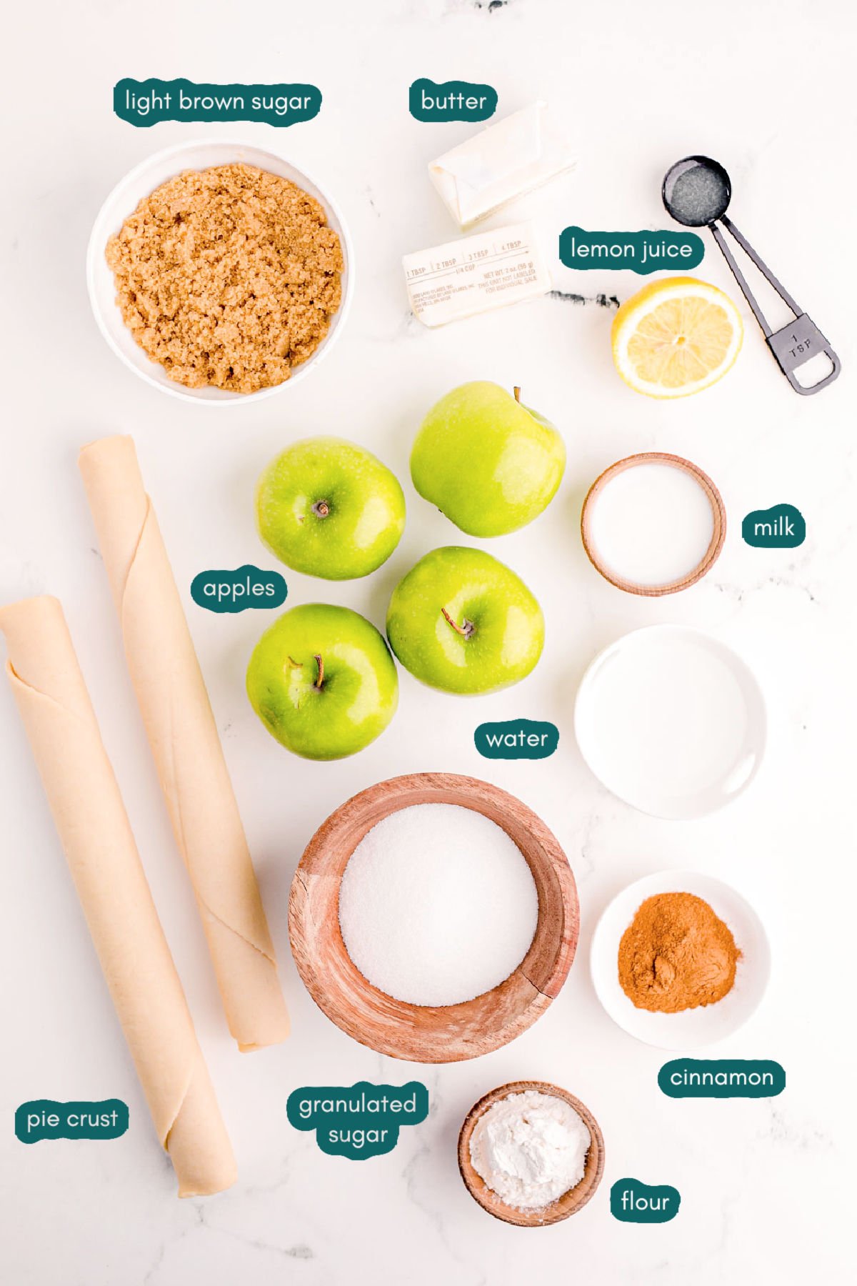 Overhead photo of ingredients used to make apple pie on a marble table.
