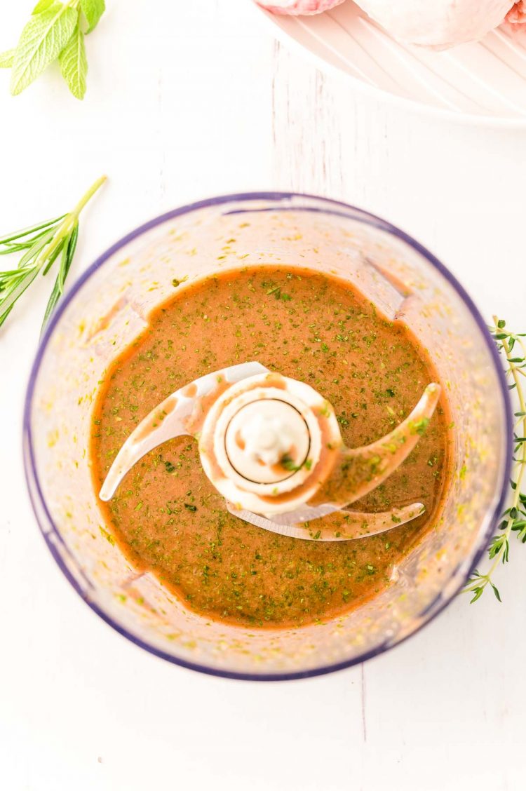 Overhead photo of a food process with chicken marinade in it.