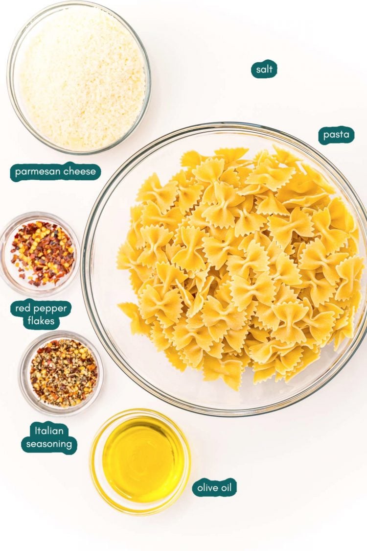 Overhead photo of ingredients to make pasta chips prepped on a white wood table.