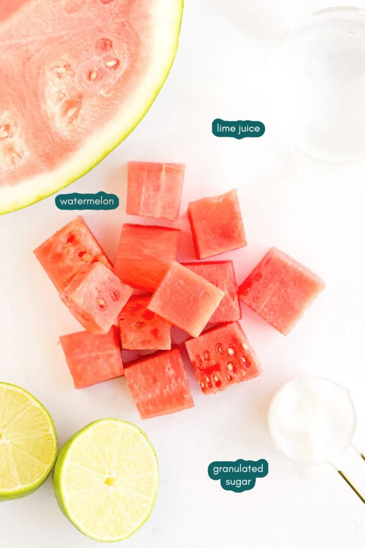 Overhead photo of ingredients used to make watermelon popsicles on a white table.