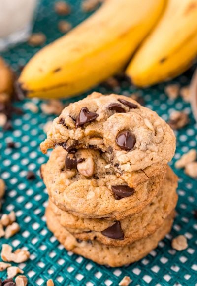 Close up photo of a stack of four banana bread cookies with the top one missing a bite.