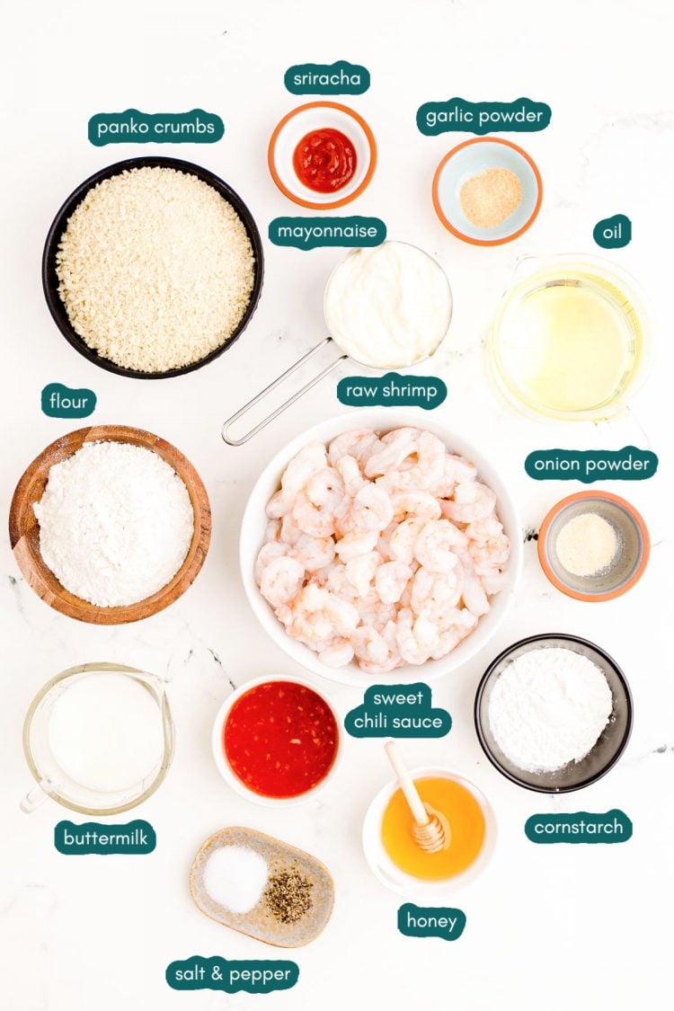 Overhead photo of ingredients prepped to make bang bang shrimp on a white marble surface.