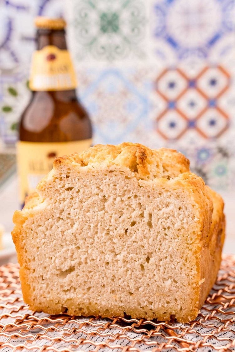 Close up photo of a loaf of beer bread that has been sliced.