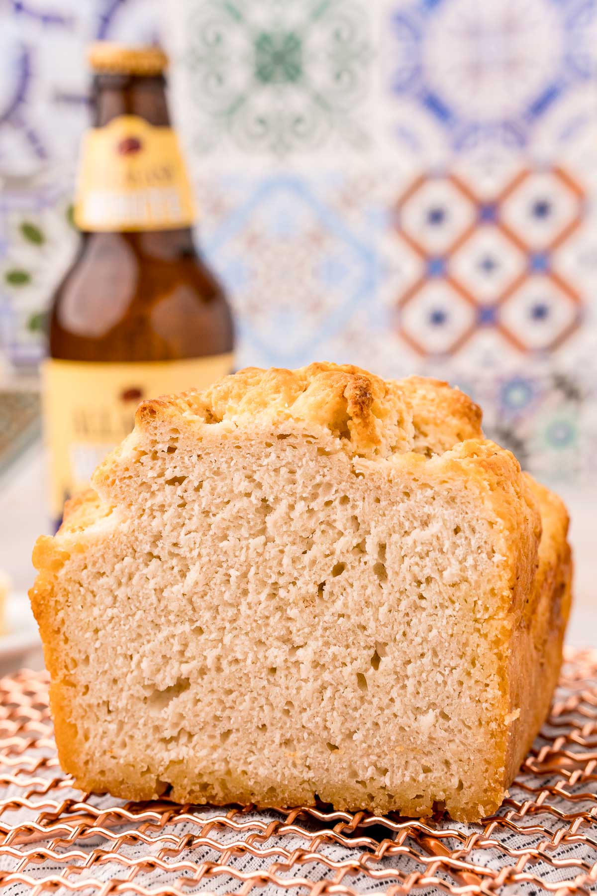 Close up photo of a loaf of beer bread that has been sliced.