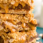 Close up photo of a stack of three carmelitas on a teal plate.