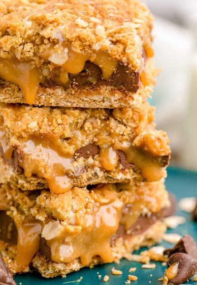 Close up photo of a stack of three carmelitas on a teal plate.