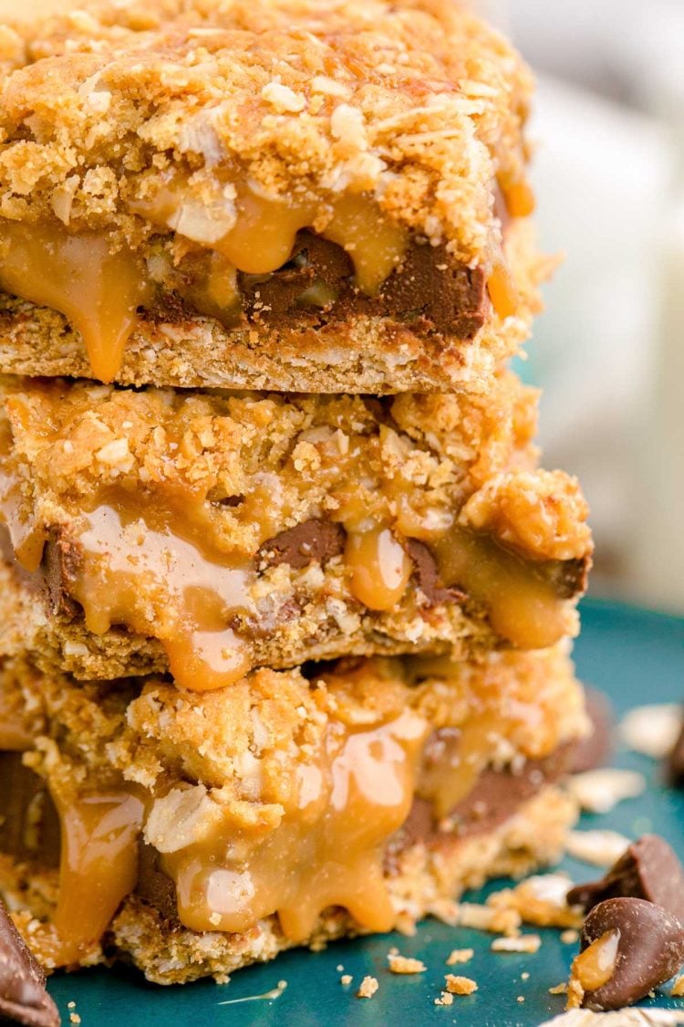 Close up photo of a stack of three carmelitas on a teal plate.