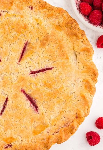 Overhead photo of a raspberry pie made with cream cheese pie crust.