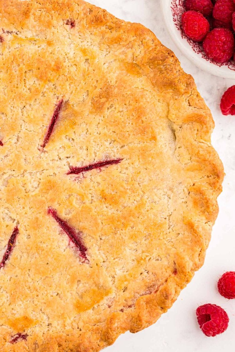 Overhead photo of a raspberry pie made with cream cheese pie crust.