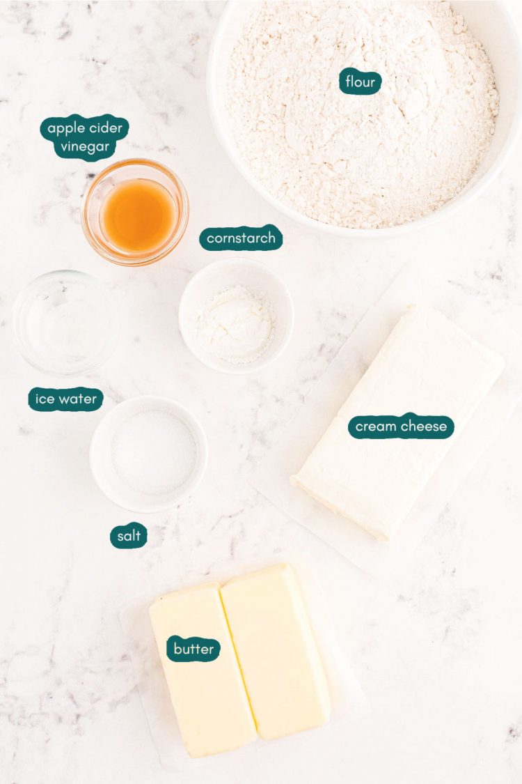 Overhead photo of ingredients used to make cream cheese pie crust prepared on a white marble surface.