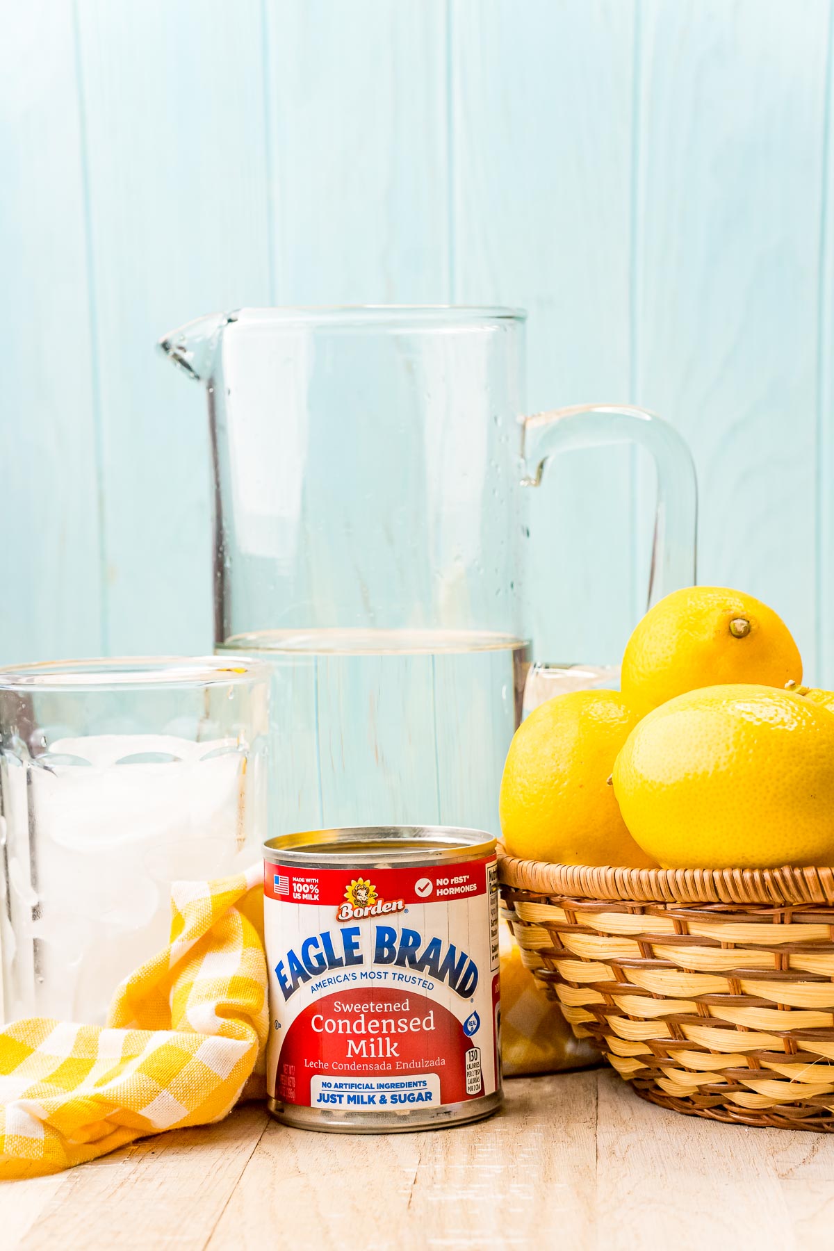 Ingredients to make creamy lemonade on a wooden counter.