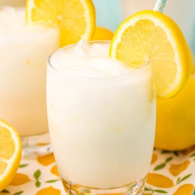 Close up photo of a glass filled with ice and creamy lemonade.