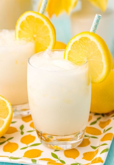 Close up photo of a glass filled with ice and creamy lemonade.