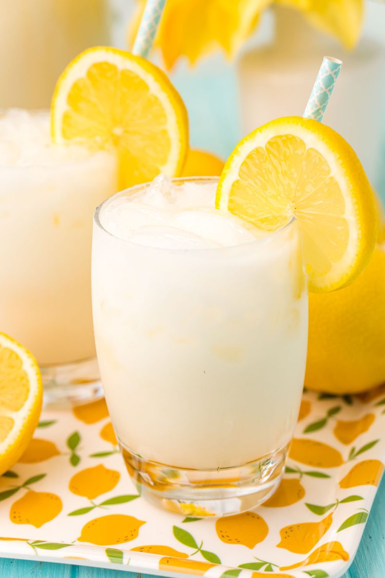 Close up photo of a glass filled with ice and creamy lemonade.