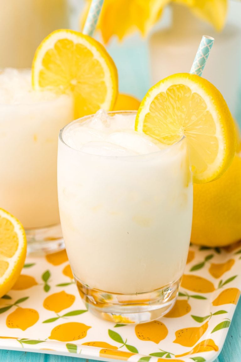 Close up photo of a glass filled with ice and creamy lemonade.