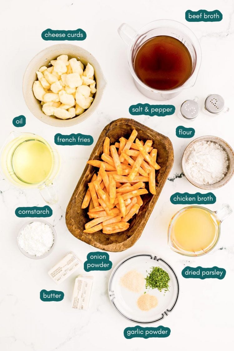 Overhead photo of ingredients to make poutine on a marble surface.