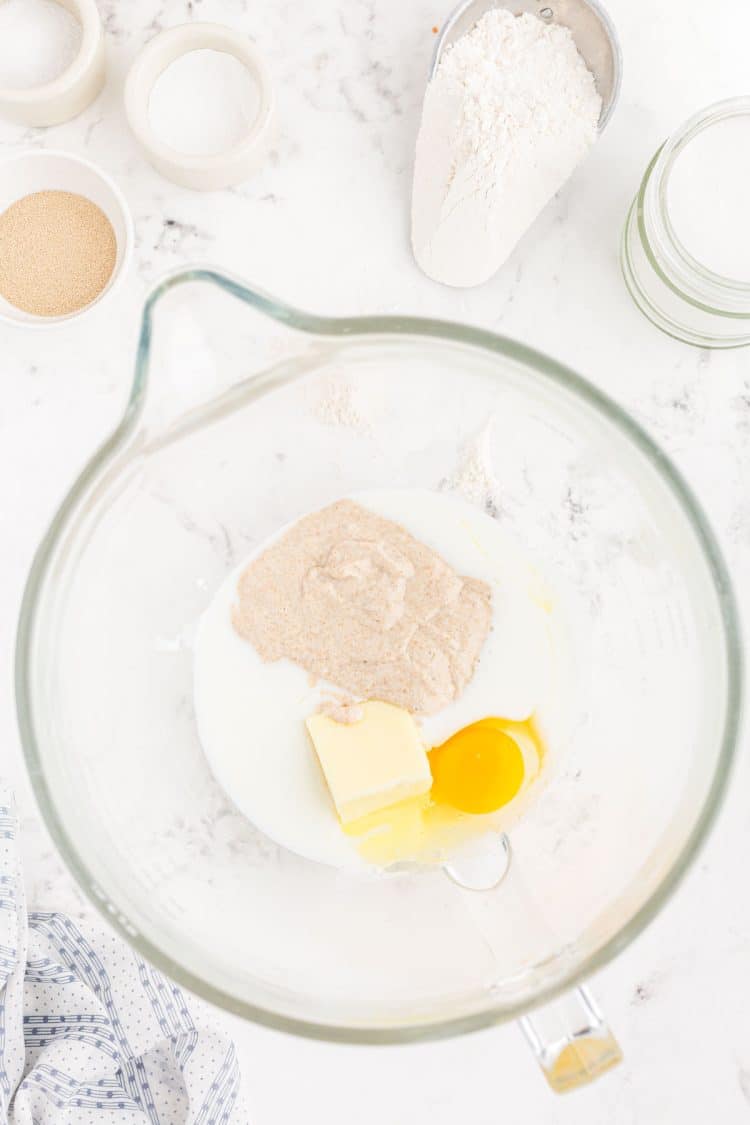 Buttermilk, butter, egg, and yeast in a mixing bowl.