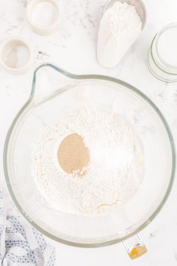 Flour, sugar, and yeast in a mixing bowl.