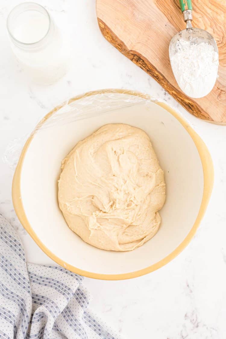 Sourdough dinner roll dough in a bowl ready to proof.