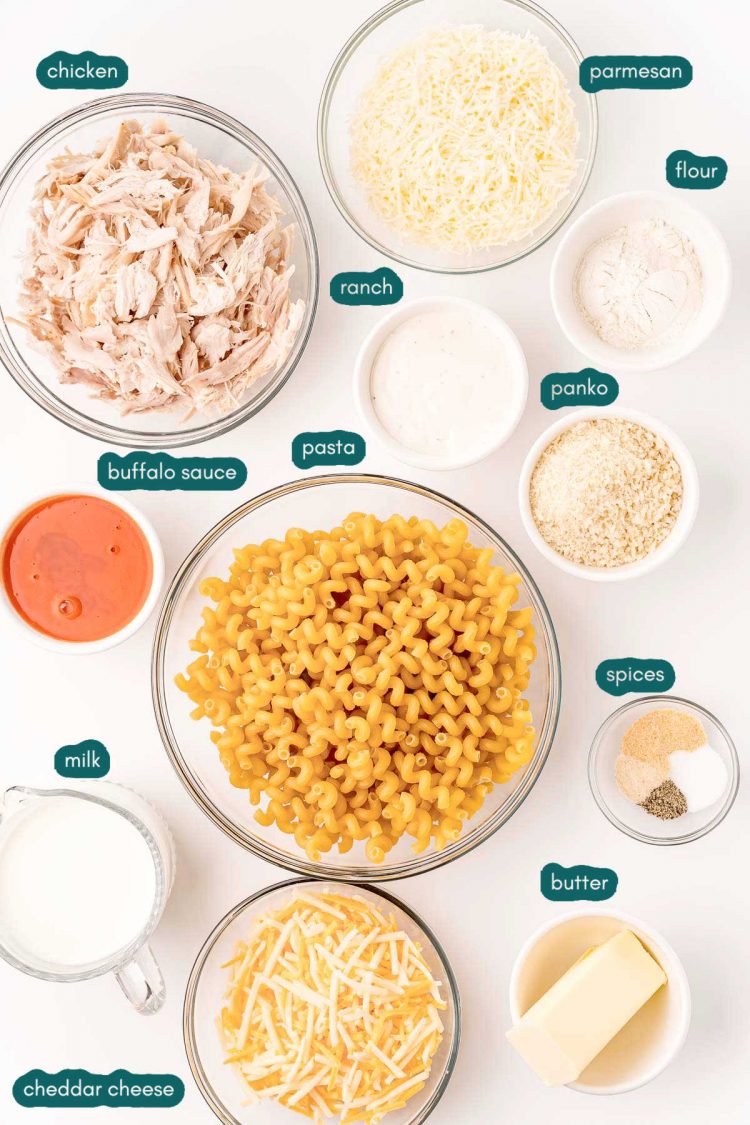 Overhead photo of ingredients prepped to make buffalo chicken mac and cheese on a white surface.