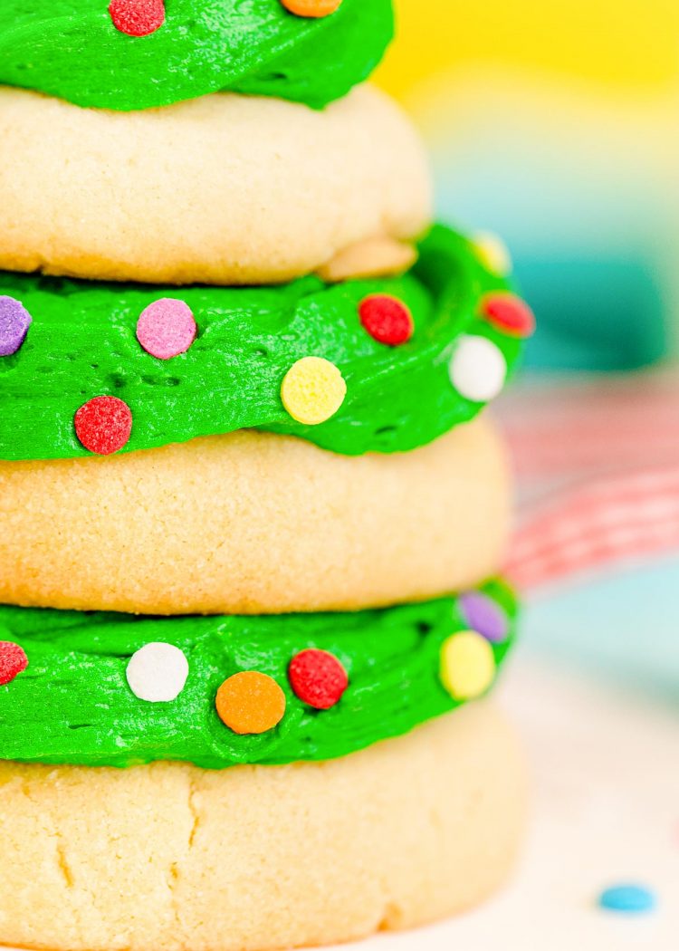 Close up photo of a stack of sugar cookies and green icing made to look like a Christmas tree.