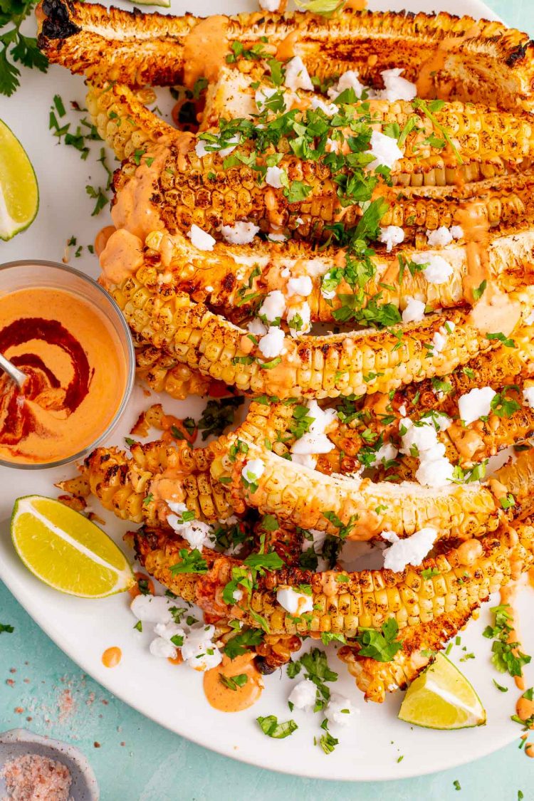 Overhead photo of a white platter with corn ribs on it.