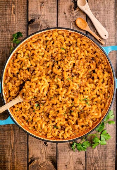 Overhead photo of homemade hamburger helper in a dutch oven on a wooden table.