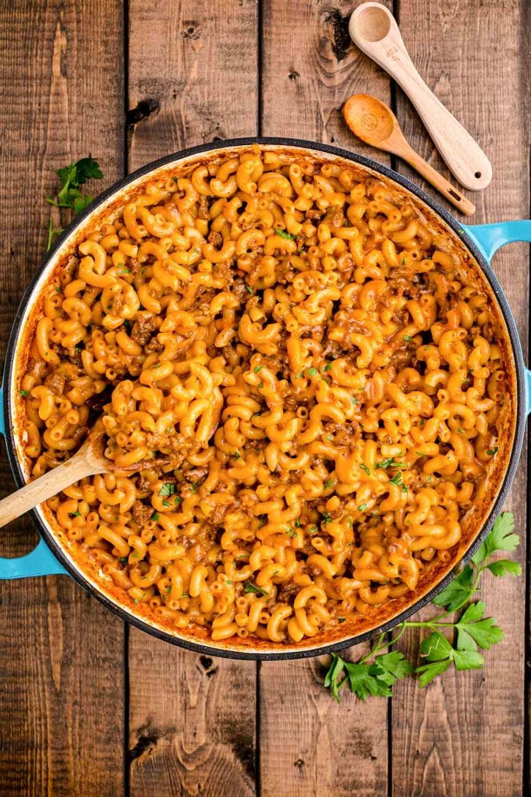 Overhead photo of homemade hamburger helper in a dutch oven on a wooden table.