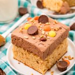 Slice of peanut butter sheet cake on a white plate.