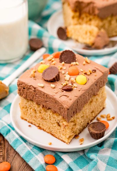 Slice of peanut butter sheet cake on a white plate.