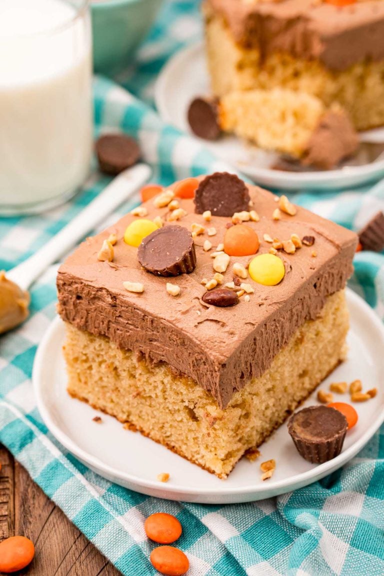Slice of peanut butter sheet cake on a white plate.