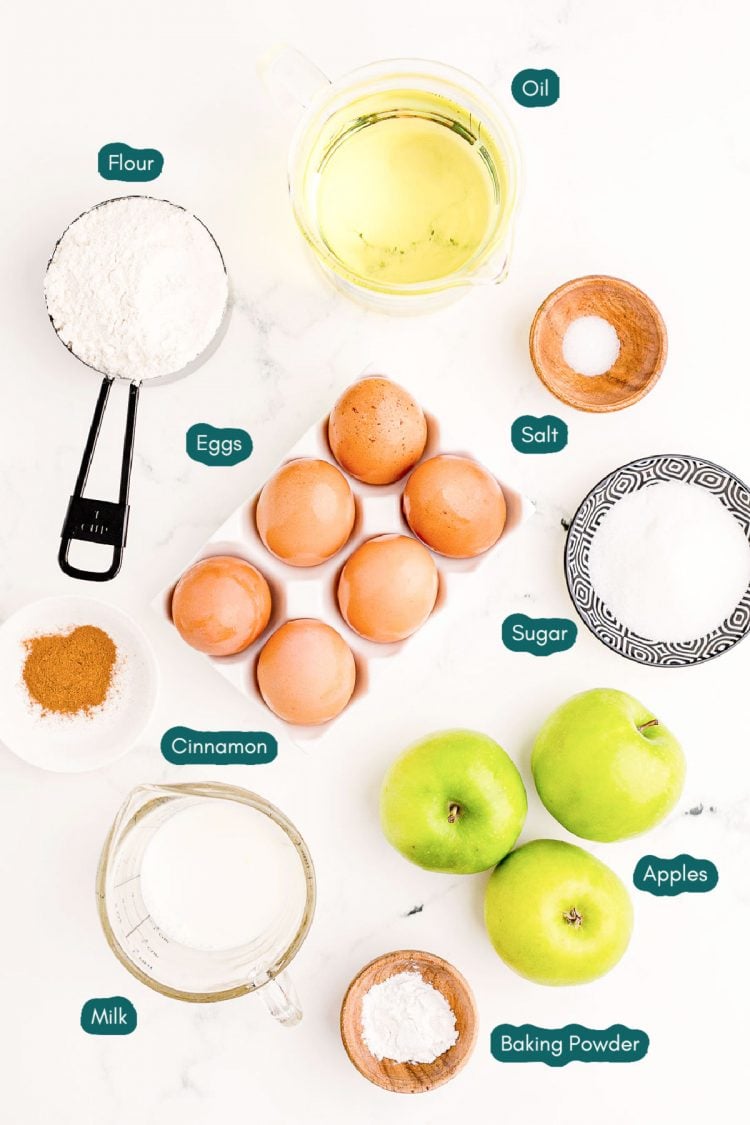 Overhead photo of ingredients to make homemade apple fritters on a marble table.