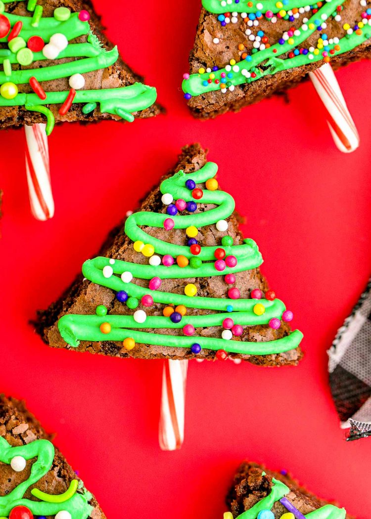 Close up photo of brownie christmas trees laying on a red surface.