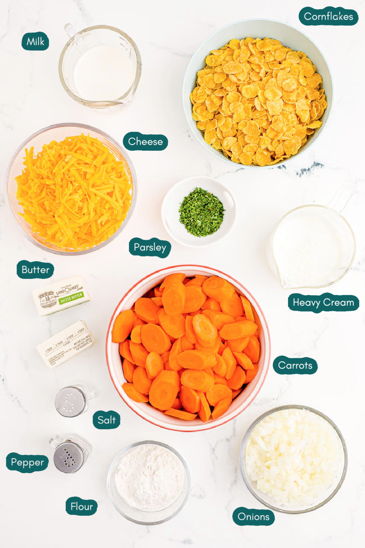 Overhead photo of ingredients prepared to make carrot casserole on a marble table.