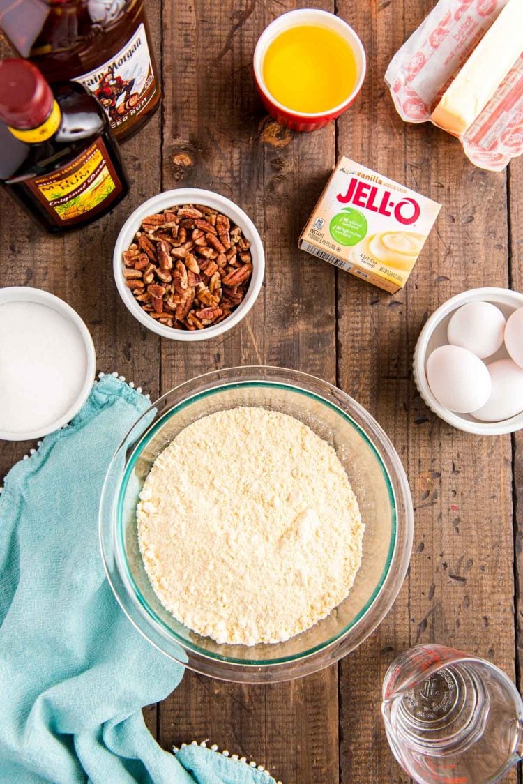 Overhead photo of ingredients to make rum bundt cake on a wooden table.