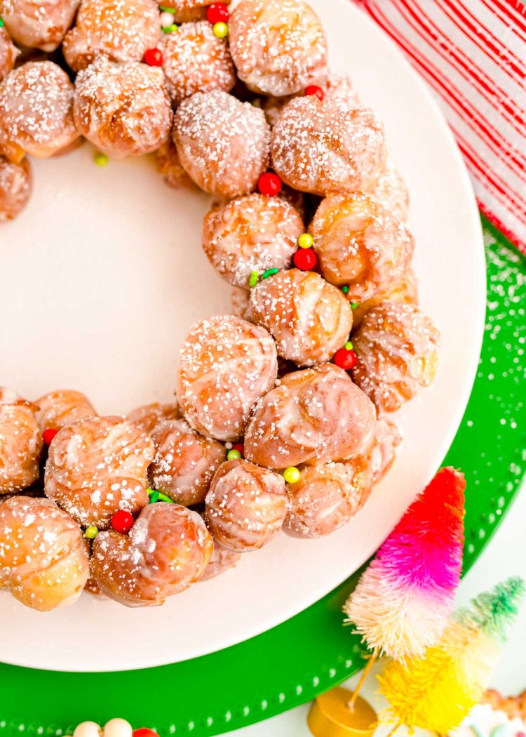 Close up photo of donut holes on a plate with holiday sprinkles.