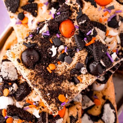 Close up photo of Halloween cookies and cream cookie bars piled on a plate.