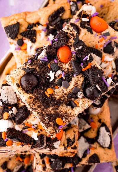 Close up photo of Halloween cookies and cream cookie bars piled on a plate.
