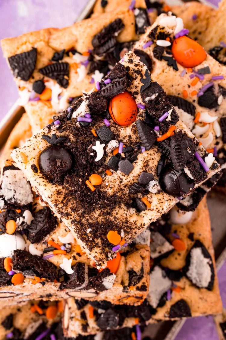 Close up photo of Halloween cookies and cream cookie bars piled on a plate.