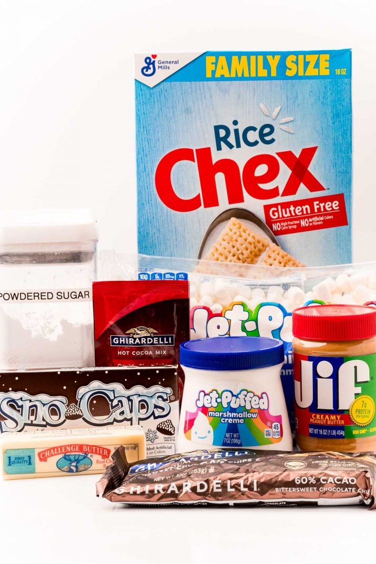 Ingredients to make hot chocolate muddy buddies on a white table.