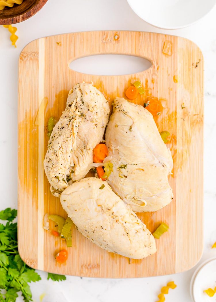 Cooked chicken on a cutting board.