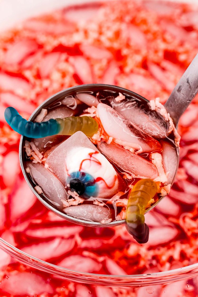 Close up photo of a ladle filled with halloween punch.