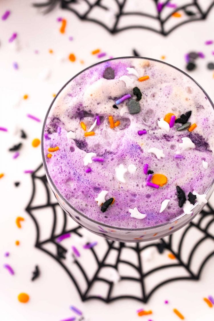 overhead photo of a glass of witch's brew Halloween party punch for kids.