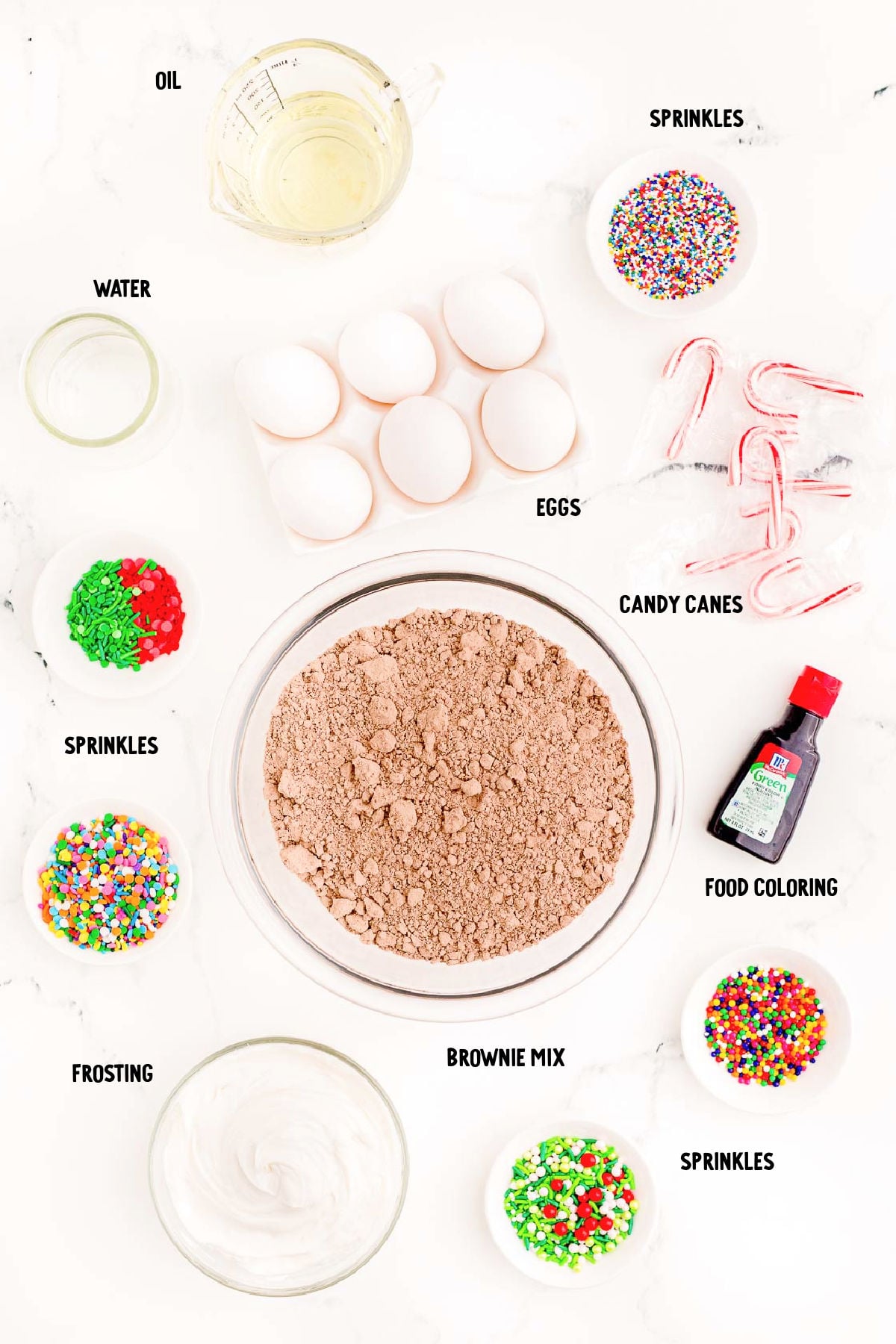 Overhead photo of ingredients for brownie Christmas trees prepped on a marble surface.